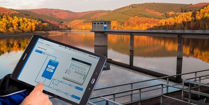 Dashboard of Netilion Water Network Insights in front of a water reservoir